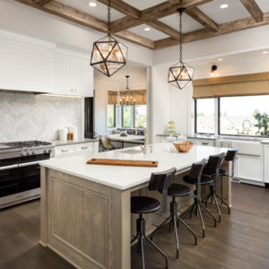 beautiful kitchen in new luxury home with island and pendant light fixtures